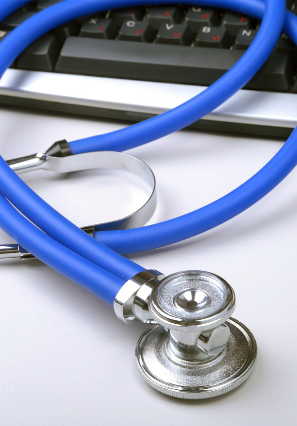 Stethoscope keyboard. A stethoscope laying across a keyboard.