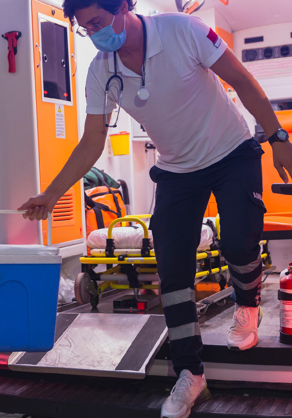 A paramedic unloading the back of an ambulance on the way to a scene